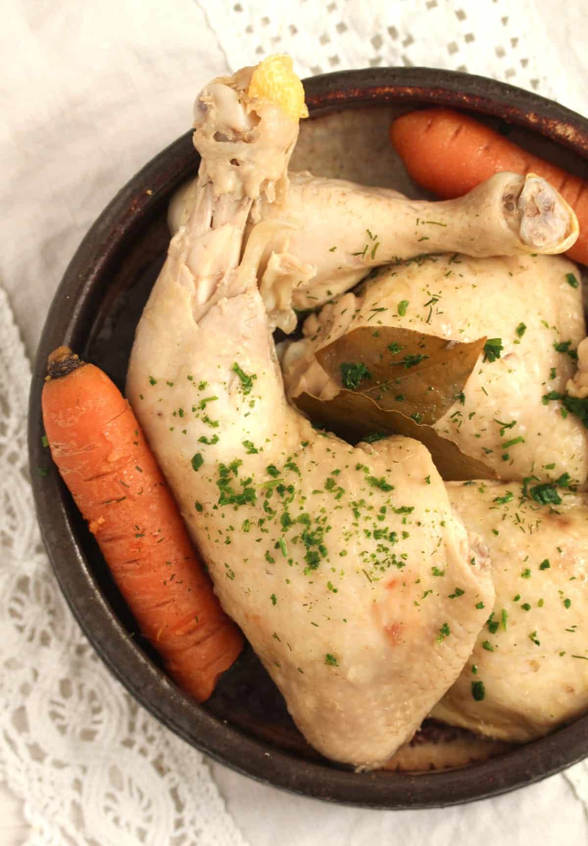 close up boiled chicken quarter with carrots.