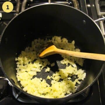 stirring golden chopped onions in a pot with a wooden spoon.