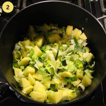 sauteing potato cubes and sliced leeks in a soup pot.
