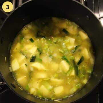 potatoes and leeks simmering in vegetable broth.