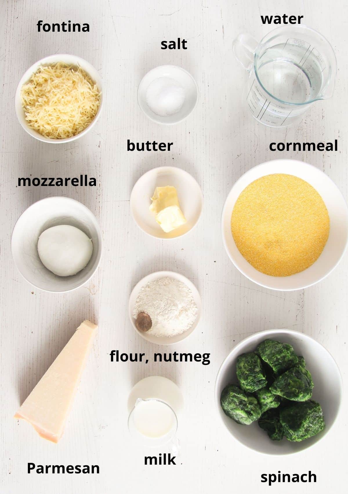 listed ingredients for polenta al forno with spinach on the table.