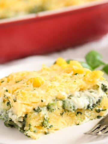 slice of polenta al forno with spinach on a plate.