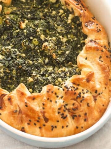 puff pastry spanakopita in a baking dish.
