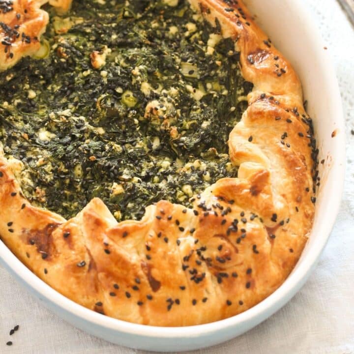 puff pastry spanakopita in a baking dish.