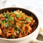 pinterest image with the title stewed cabbage.