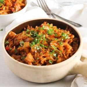 a small clay pot full of stewed cabbage.