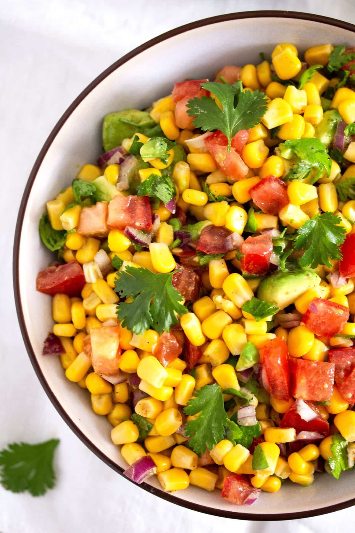 close up mexican fiesta salad with avocado, tomatoes and corn.