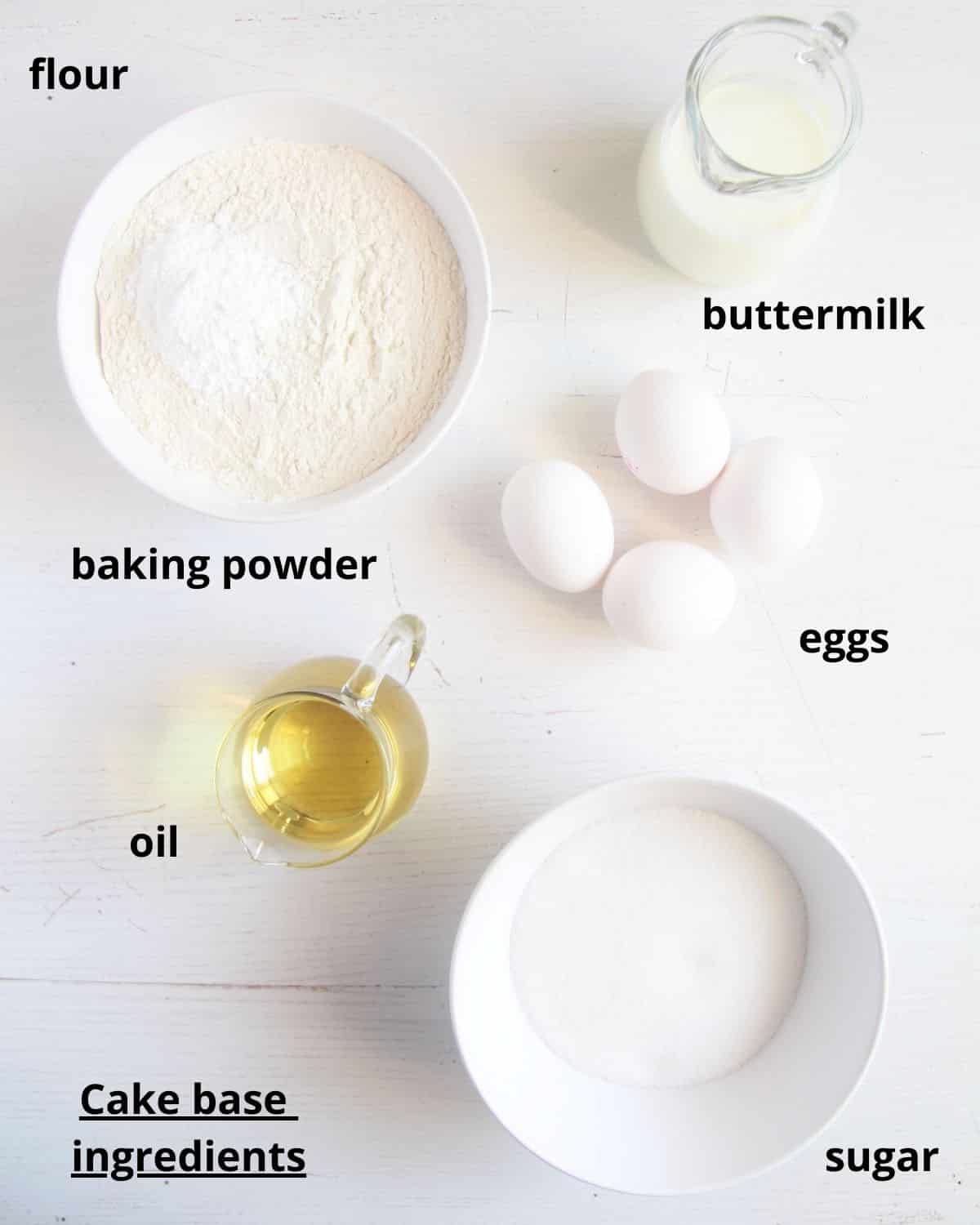 listed ingredients for making simple cake batter on a white table.