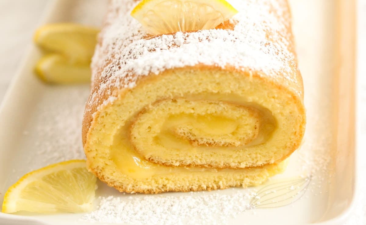 swiss roll with lemon filling on a platter.