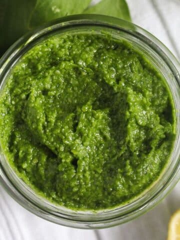 overhead view of a jar containing lovage pesto.