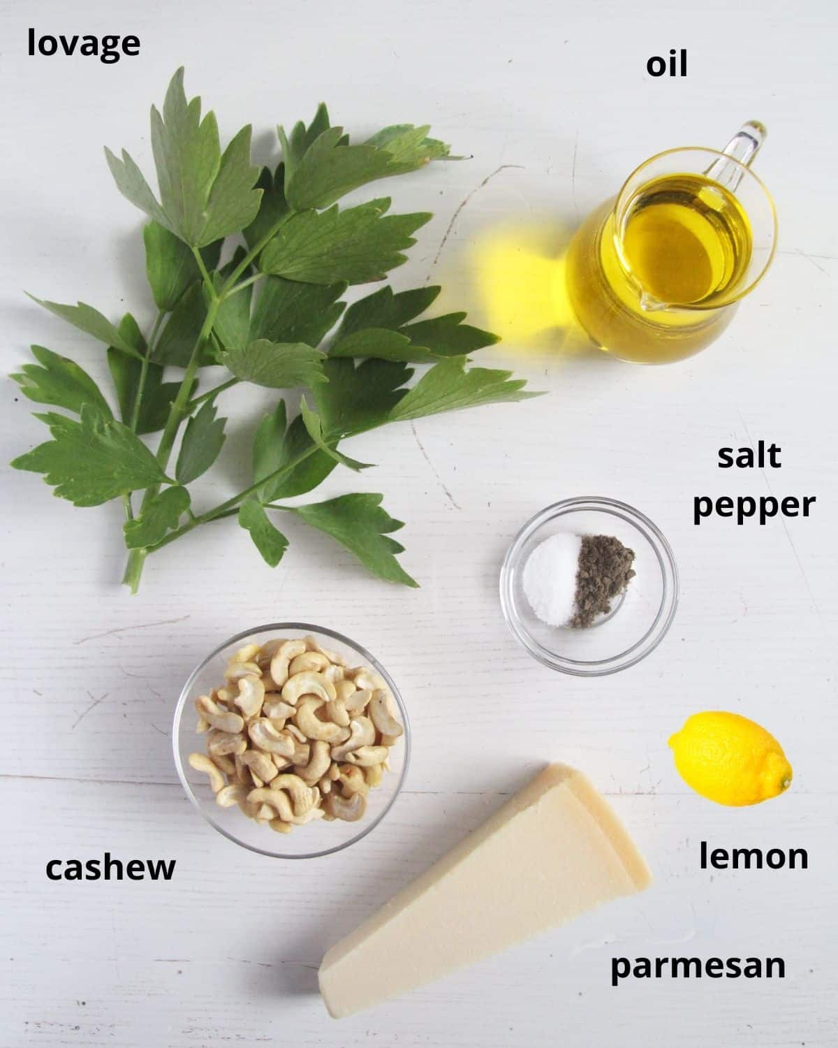 listed ingredients for making lovage pesto with cashews, parmesan and lemon.