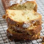 three stapled slices of rhubarb and ginger cake on a wire rack.