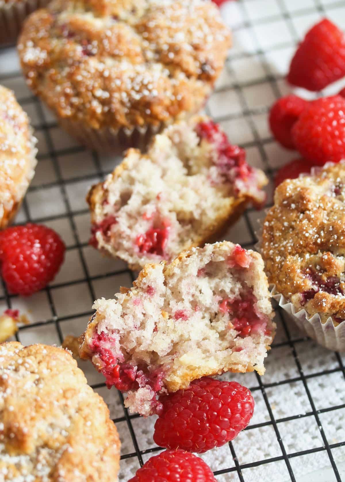 close up of a muffins with raspberries showing the moist crumb.