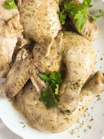 boiled chicken pieces on a platter close up.