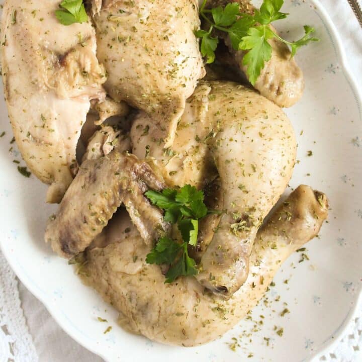 boiled chicken pieces on a platter close up.