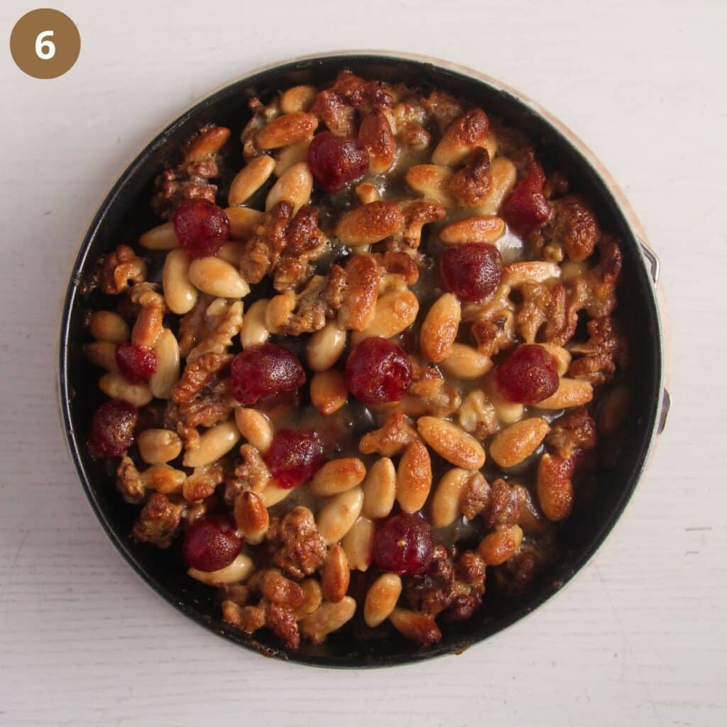 baked mincemeat christmas cake topped with nuts and cherries.