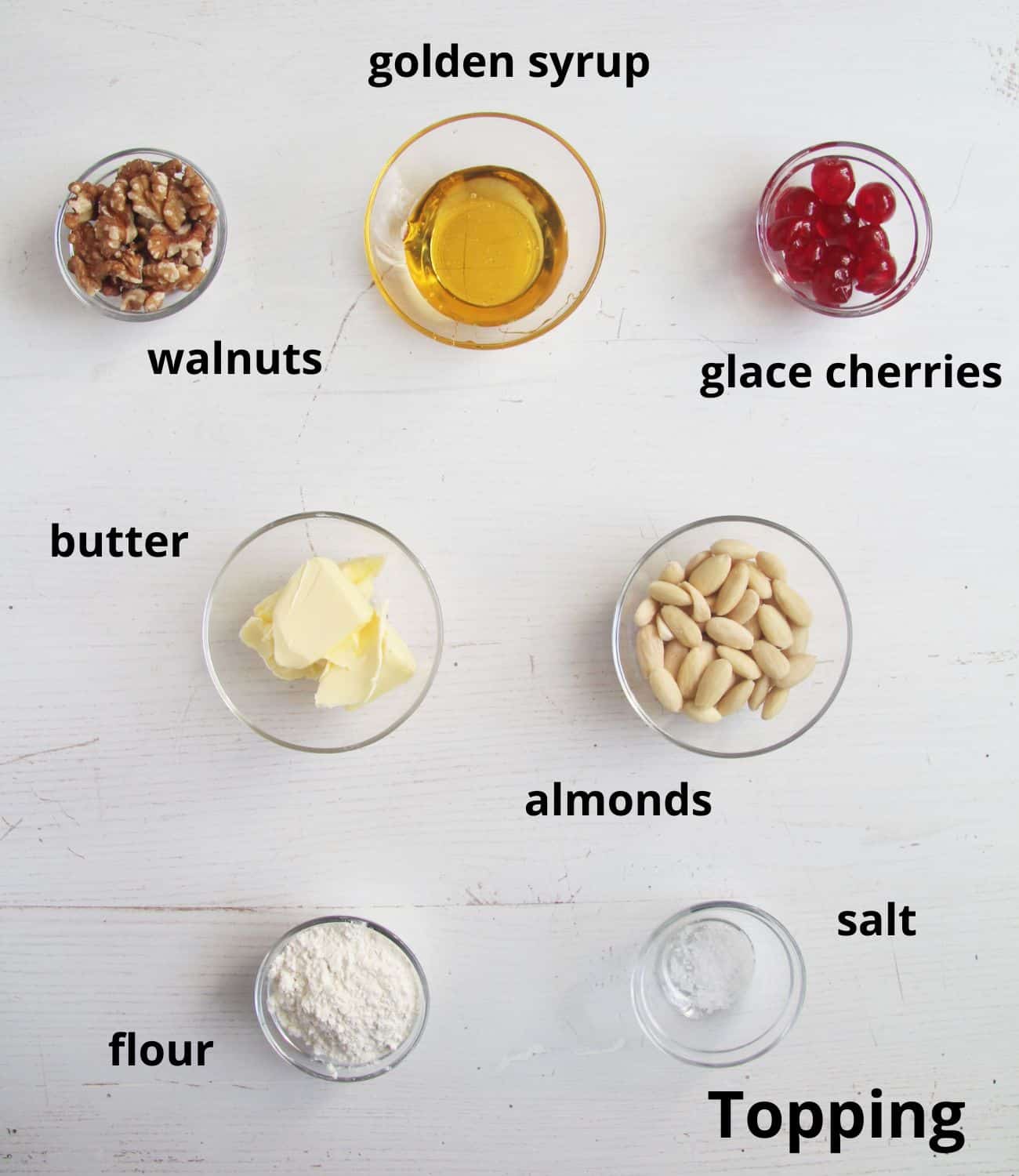 listed ingredients for almond cherry topping for fruit cake.