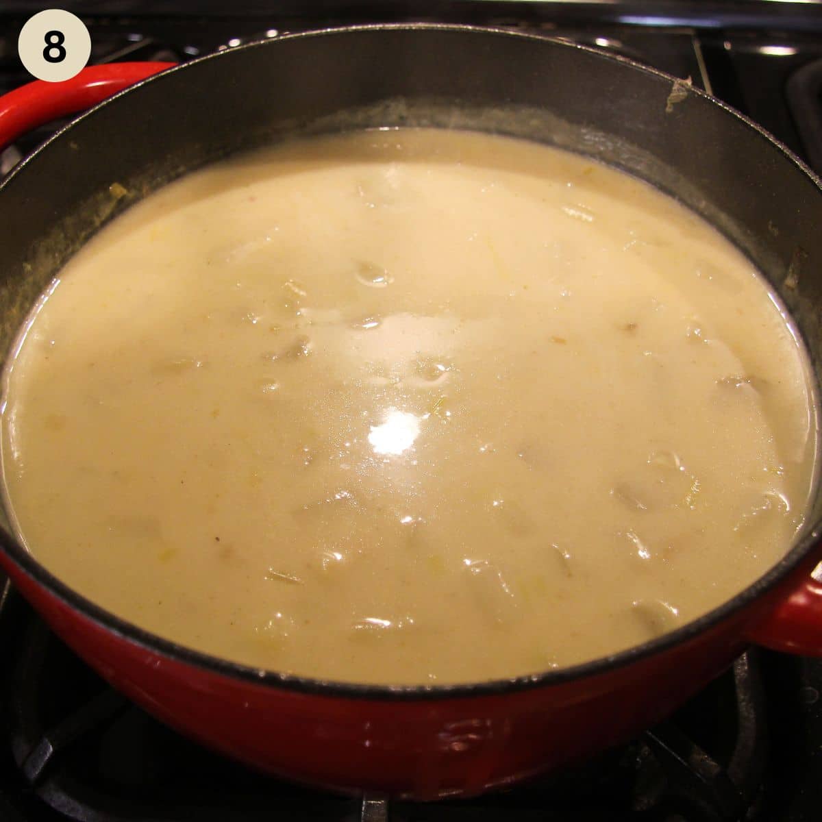 creamy soup with asparagus in a large pot.