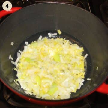 sauteing leeks in a pot to make asparagus soup.