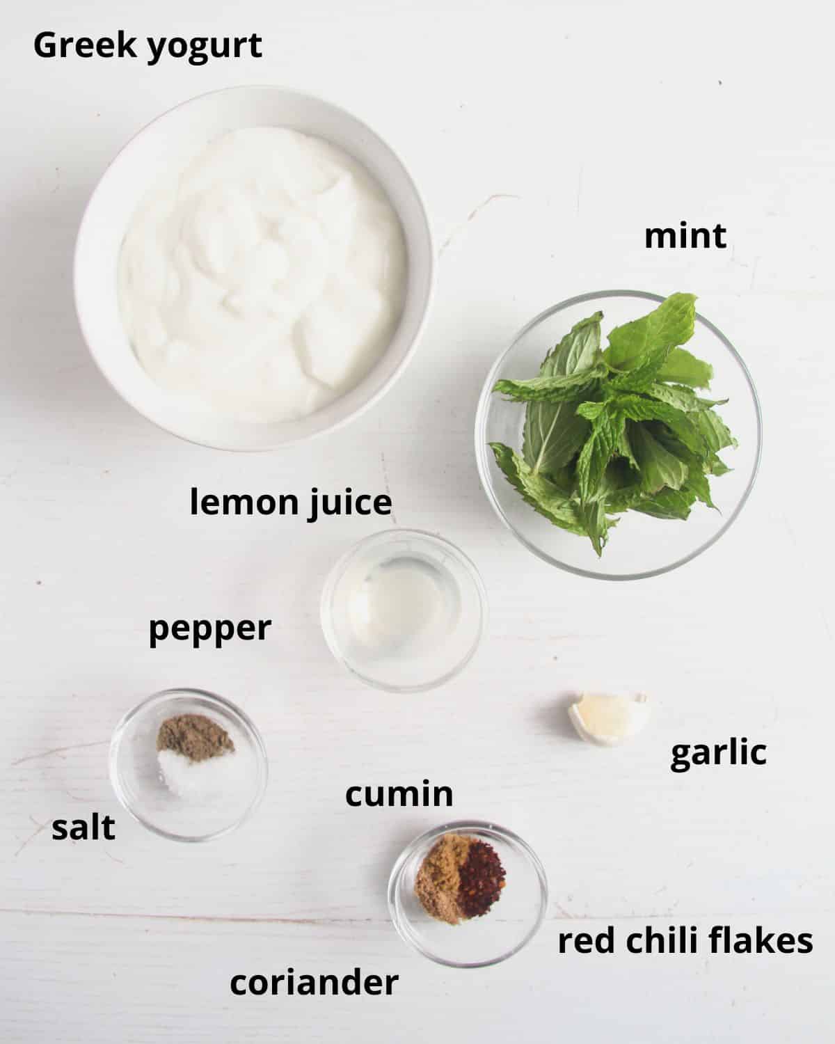 listed ingredients for making yogurt sauce on the table.