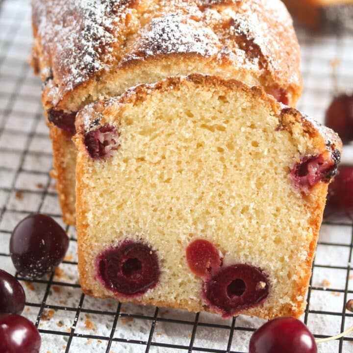 close up of a slice of cherry bread on a rack.