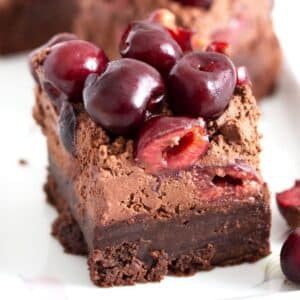 one cherry brownie with fresh cherries on top.
