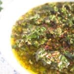 pinterest image of a glossy bowl with chimichurri with title.
