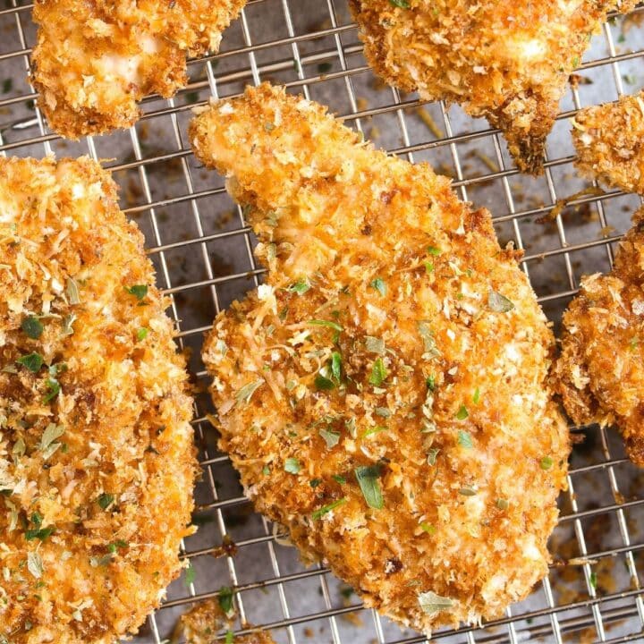 close up pieces of golden panko breaded chicken on a rack.
