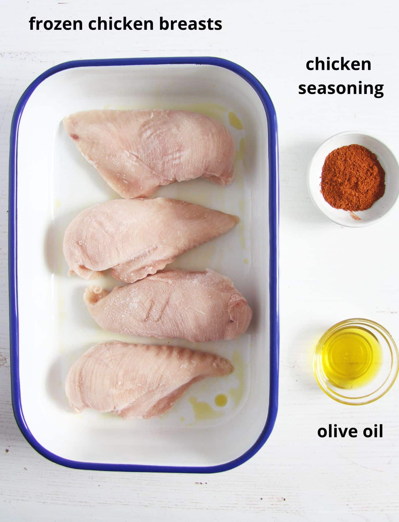 raw chicken breast pieces in a baking dish, one bowl of seasoning and one with oil.