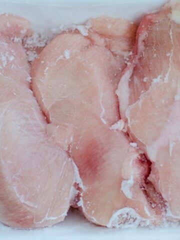 frozen chicken breast pieces close up.