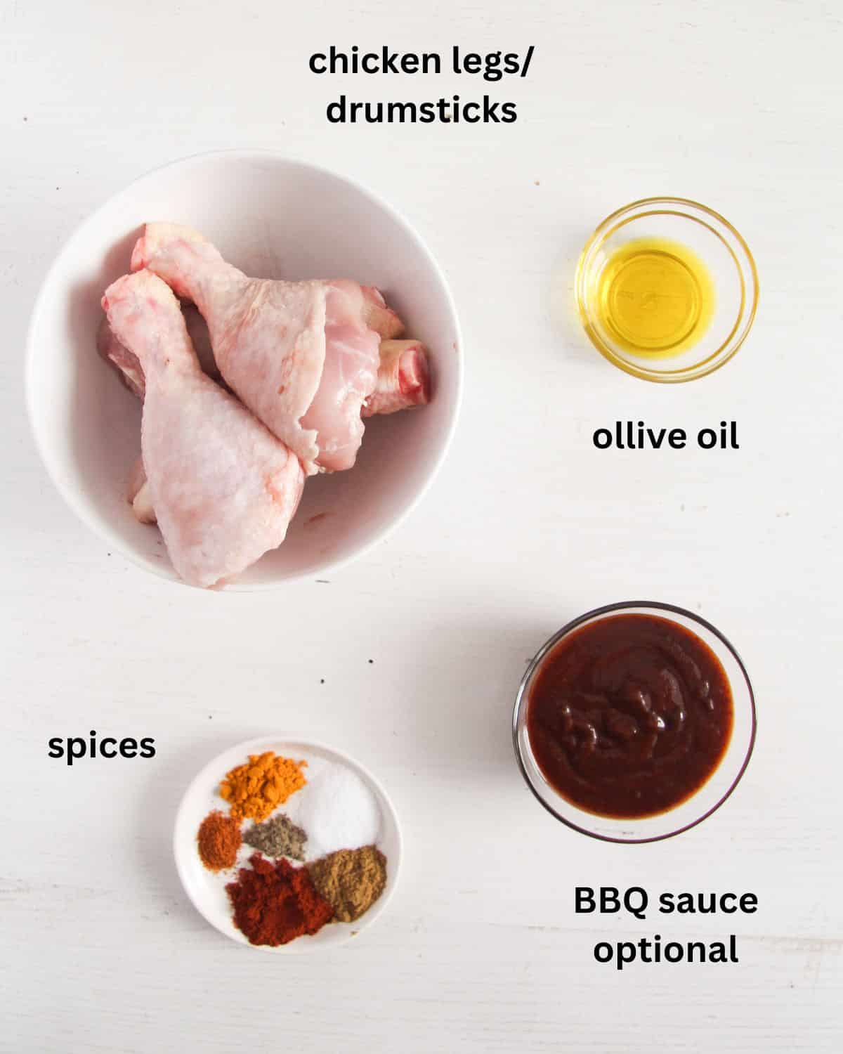 raw drumsticks, spice, oil and bbq sauce in bowls.