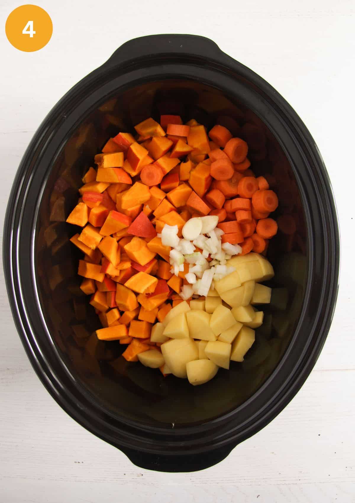 chopped vegetables in a slow cooker before cooking.