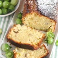 sliced quick bread with unripe tomatoes on a green white cloth.