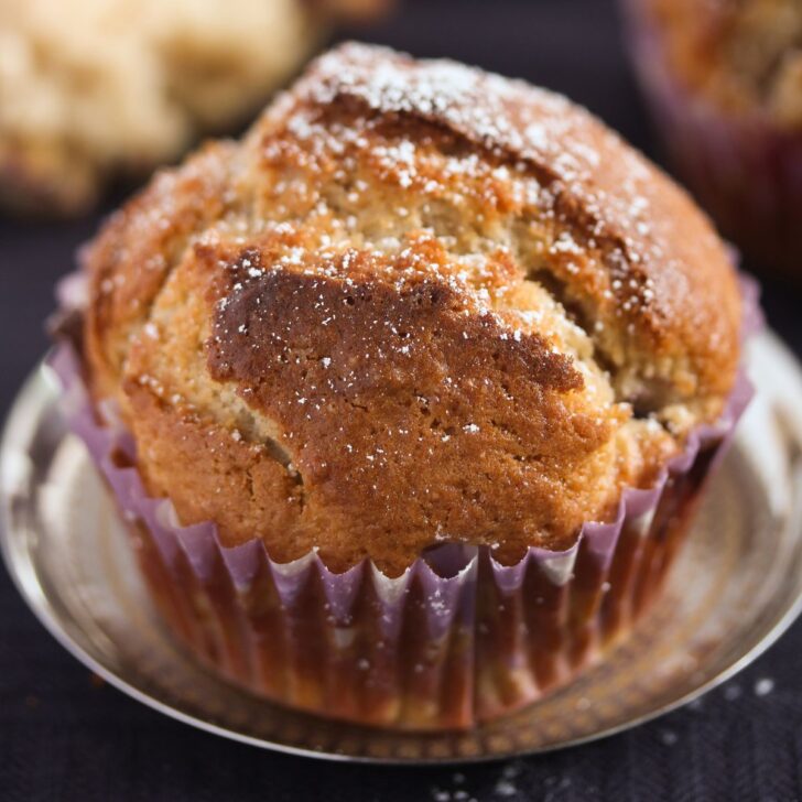 one plum muffin on a small silver plate.