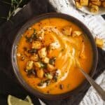 pinterest image with title of pumpkin soup with potato topping.