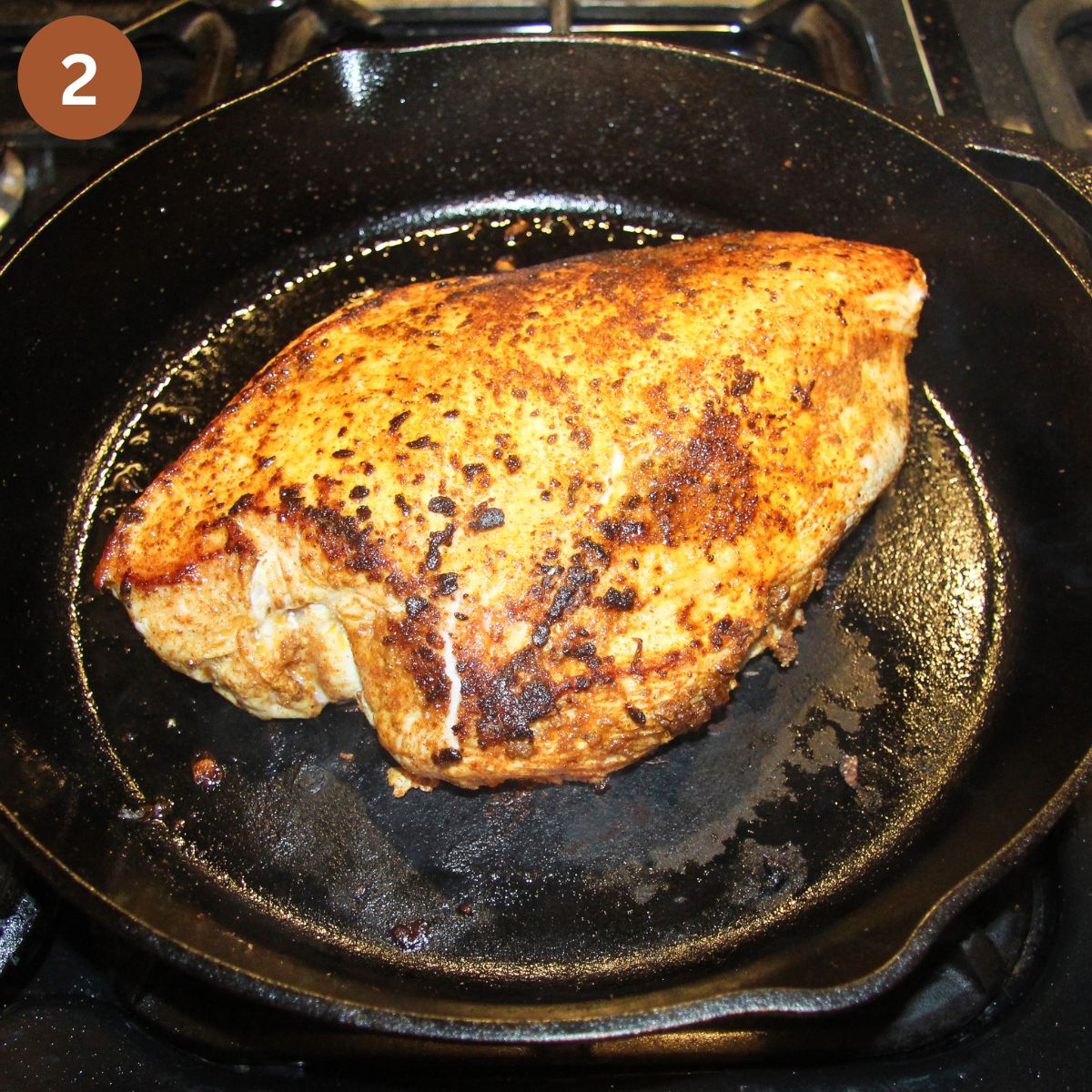 searing a large piece of turkey breast in a cast iron skillet.