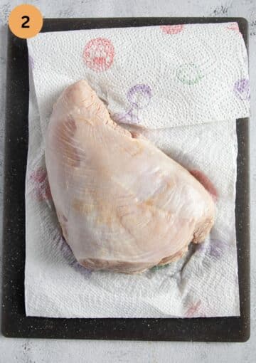 piece of brined turkey breast on paper towels.