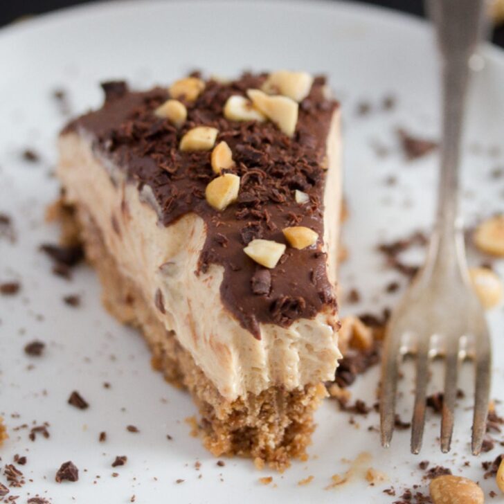 slice of peanut butter pie sprinkled with chocolate and peanuts on a plate.