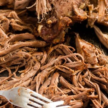 close up pulled turkey shredded with forks.