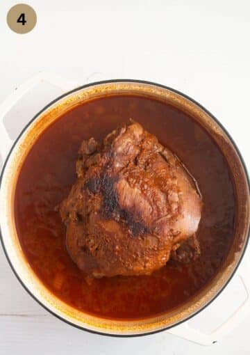 pulled turkey thigh in sauce in a large dutch oven.