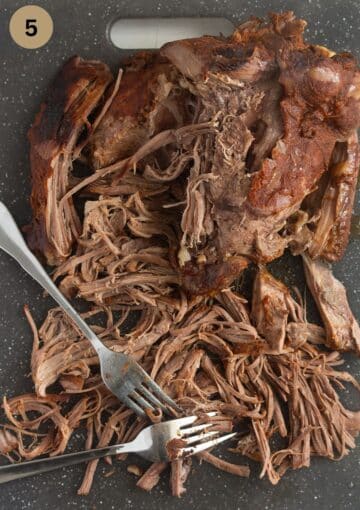 shredding pulled turkey with two forks.