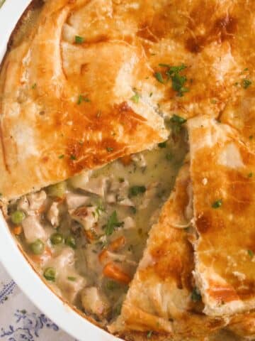 close of turkey pot pie with puff pastry showing the creamy filling.