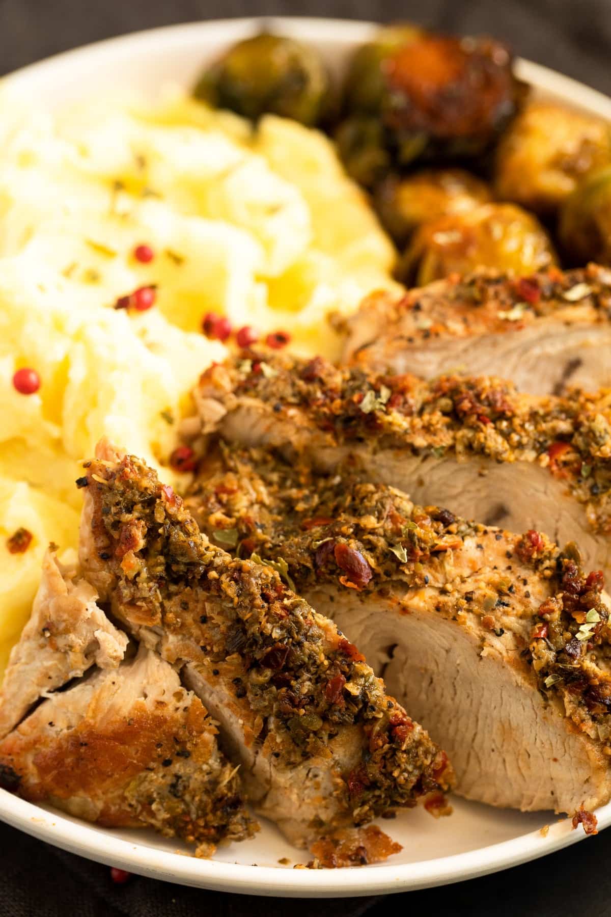 close up of a plate with turkey slices, mashed potatoes and sprouts.