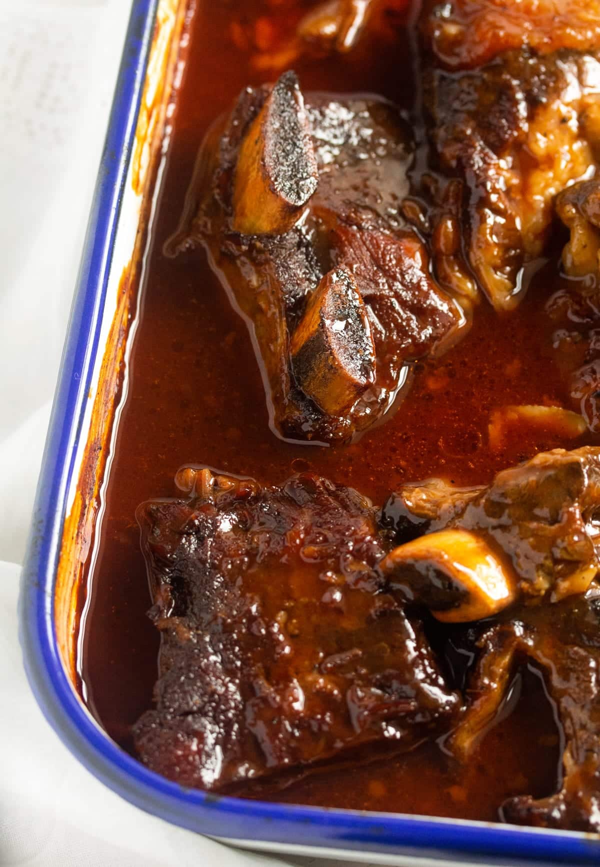 slow cooked beef ribs in the oven with bbq sauce.