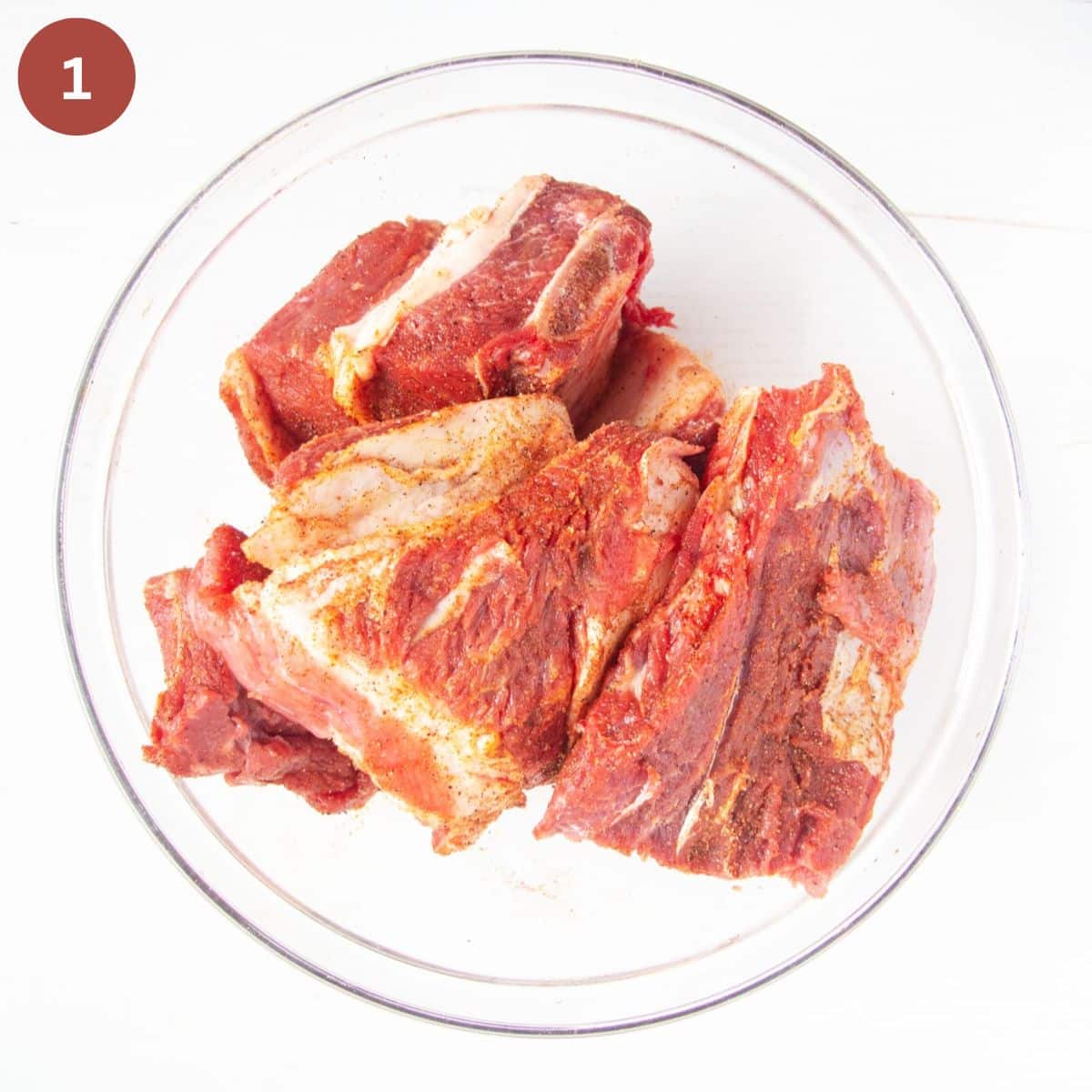 seasoned beef ribs in a bowl.