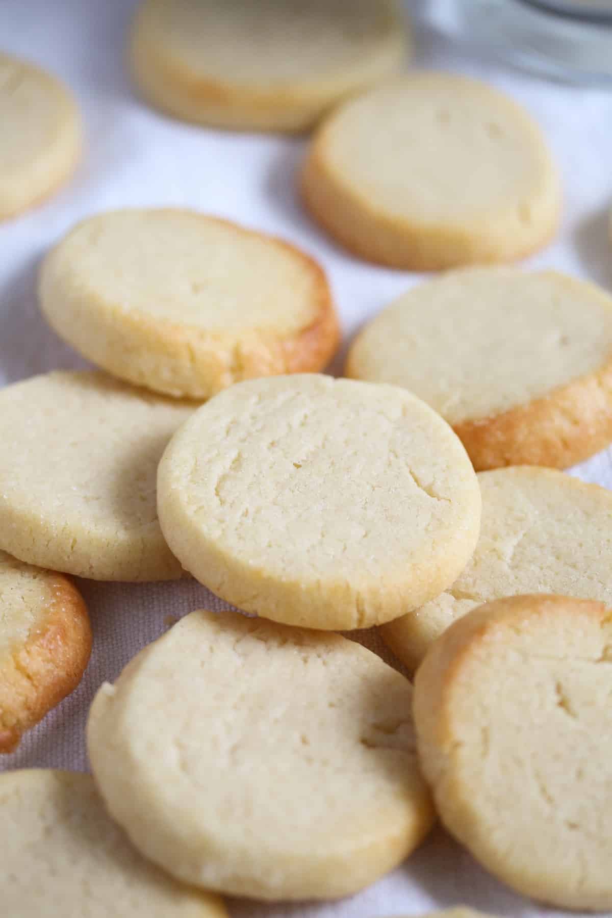 many round biscuits with sweetened condensed milk on the table.