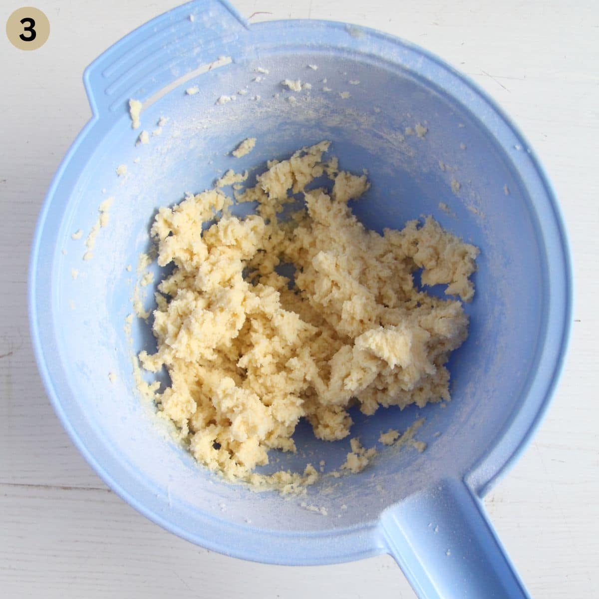 dough for making biscuits with sweetened condensed milk in a blue bowl.