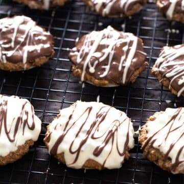 german gingerbread cookies glazed with white and dark chocolate on a wire rack.