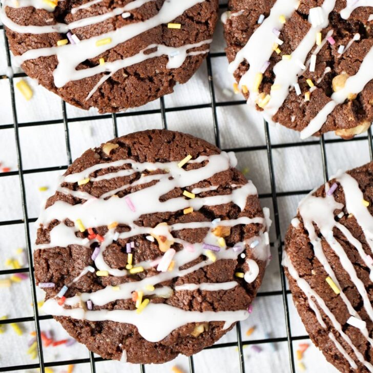 close up italian chocolate cookies with glaze and sprinkles on top.