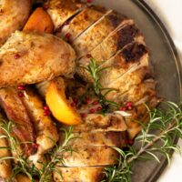half a vintage plate with carved turkey pieces and rosemary.